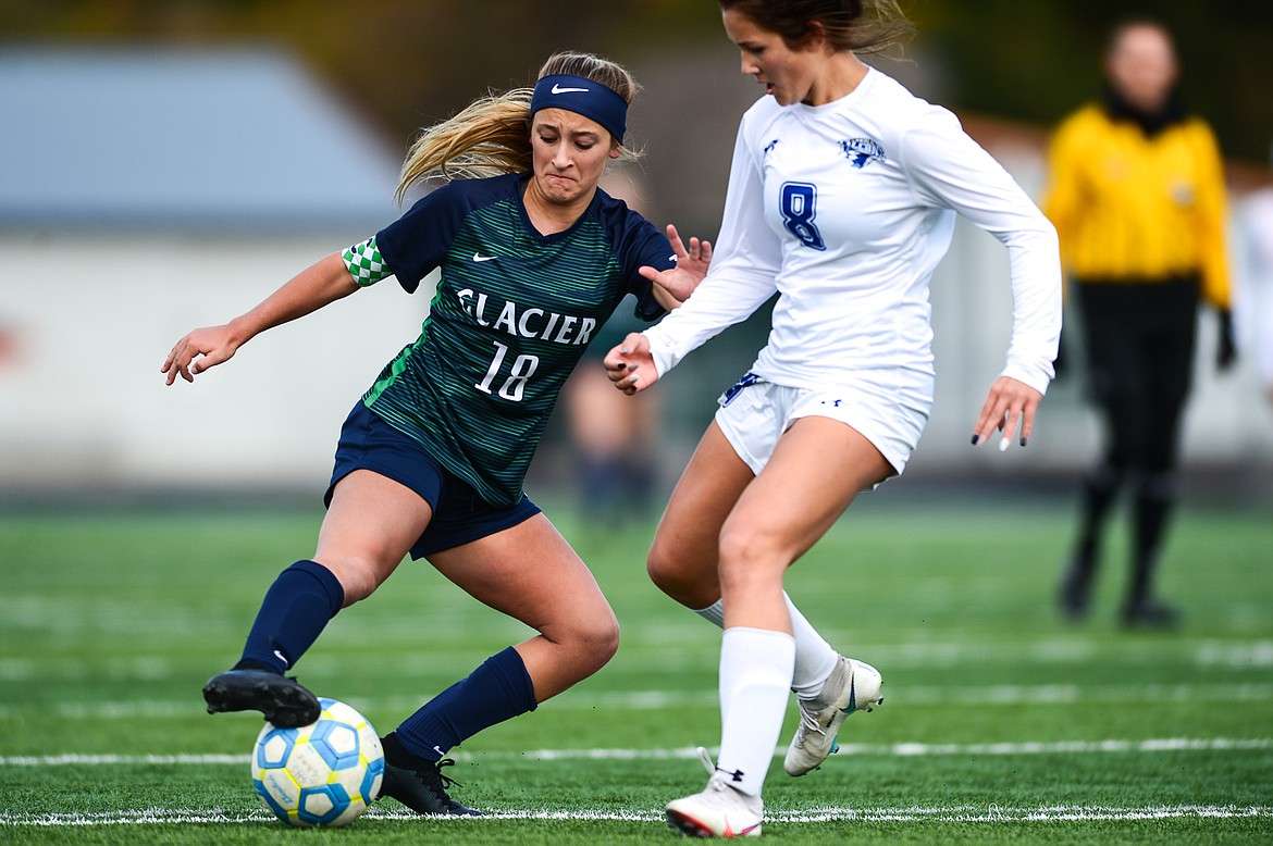 Glacier's Madison Becker (18) pushes the ball upfield against Billings Skyview's Emily Gipe (8) in the first half at Legends Stadium on Saturday. (Casey Kreider/Daily Inter Lake)