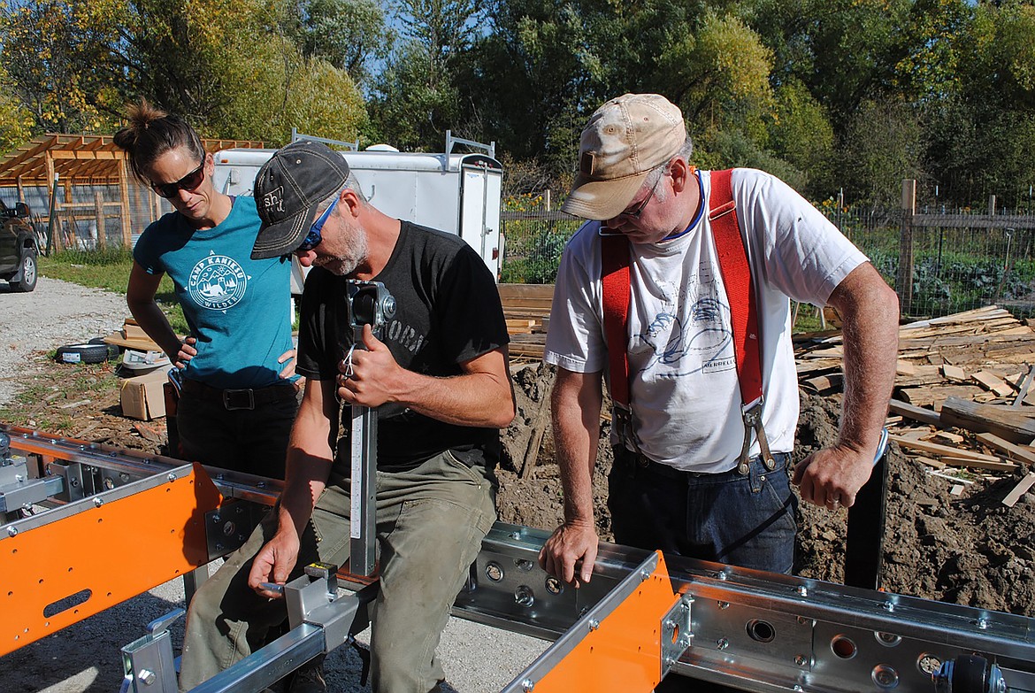 Volunteers work to put together a portable sawmill at Kaniksu Land Trust's Pine Street Woods Community Forest.