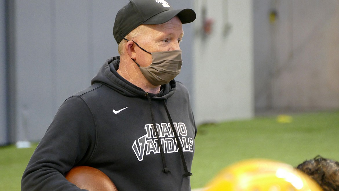 Courtesy Idaho media relations
A masked Idaho coach Paul Petrino watches practice Saturday at the Kibbie Dome.