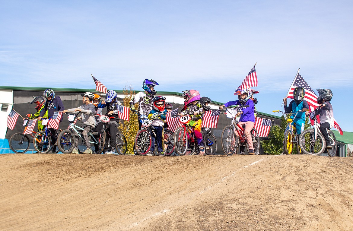 Riders gather together for the comparative "flag lap" to begin things at the final event of the season for Moses Lake BMX on Saturday.