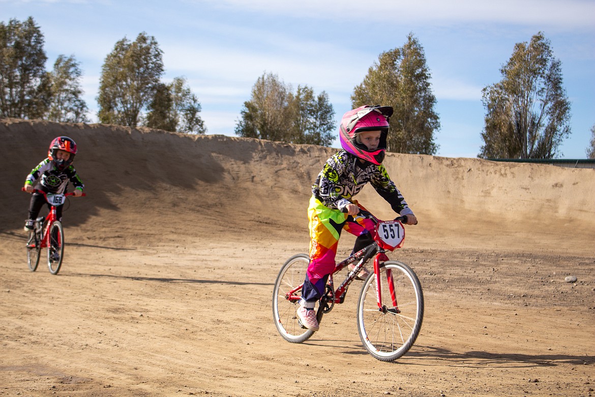 Jude Scott, right, powers ahead during a race with Jordan Niehenke coming up in pursuit at the final BMX event of the season at the track in Moses Lake.