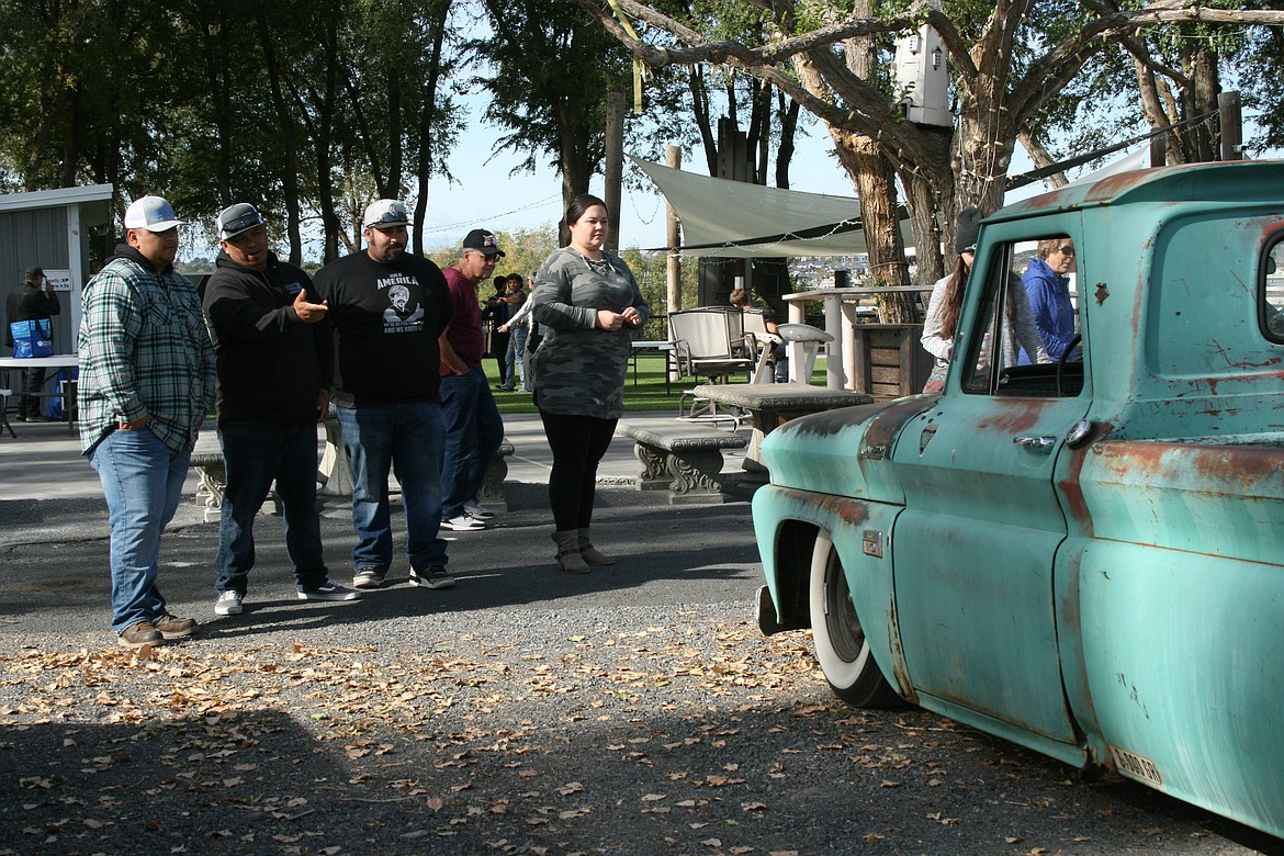 Car fans check out a work in progress at the car show in Zamora Park in Moses Lake Saturday.