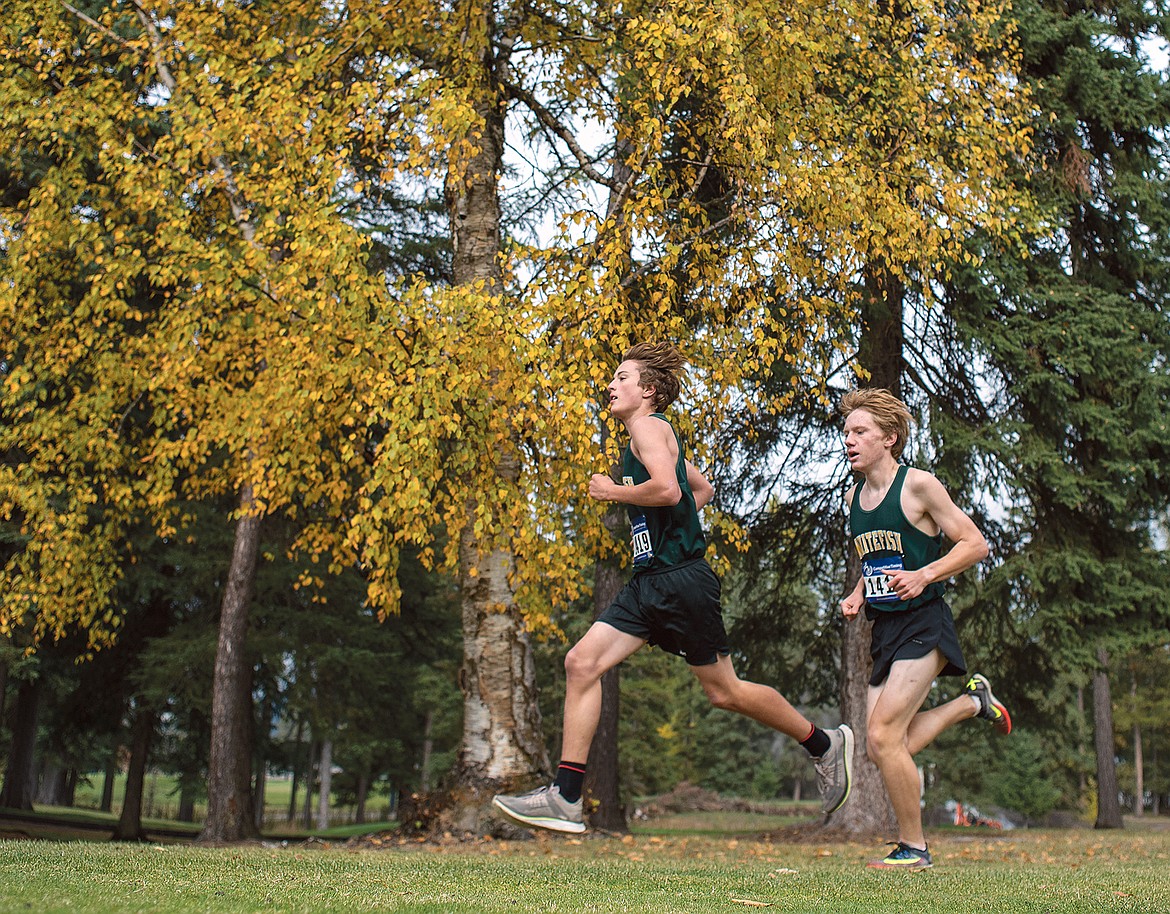 Whitefish's Deneb Linton and Jacob Henson run alongside each other during the Western A Fall Classic cross country meet Saturday at the Whitefish Lake Golf Course. (Chris Peterson/Hungry Horse News)