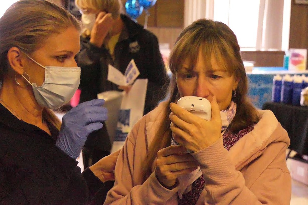 Clark Fork Valley Hospital representative Janie Hom tests the CO-2 level of Toastmaster member Cindy Thomas at Saturday’s health fair at the Plains VFW. (Chuck Bandel/Valley Press)