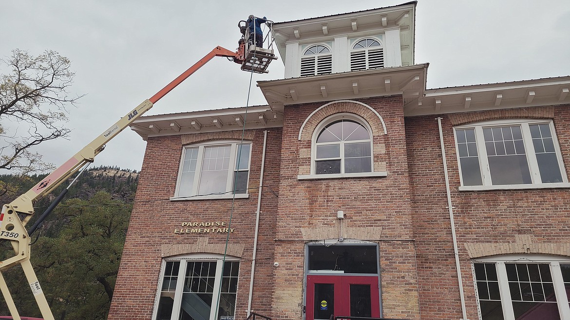 The Stamm family, including Don, Alan and Bob, worked together to help clean the Paradise Center with a power washer recently. The historic building was an elementary school from 1910-2013. It serves as a community center for many different events, but the coronavirus has temporarily halted them. (Photo courtesy Alan Stamm)