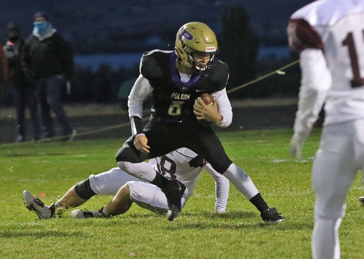 Polson quarterback Jarrett Wilson looks for room during a run against Butte Central. (Bob Gunderson)