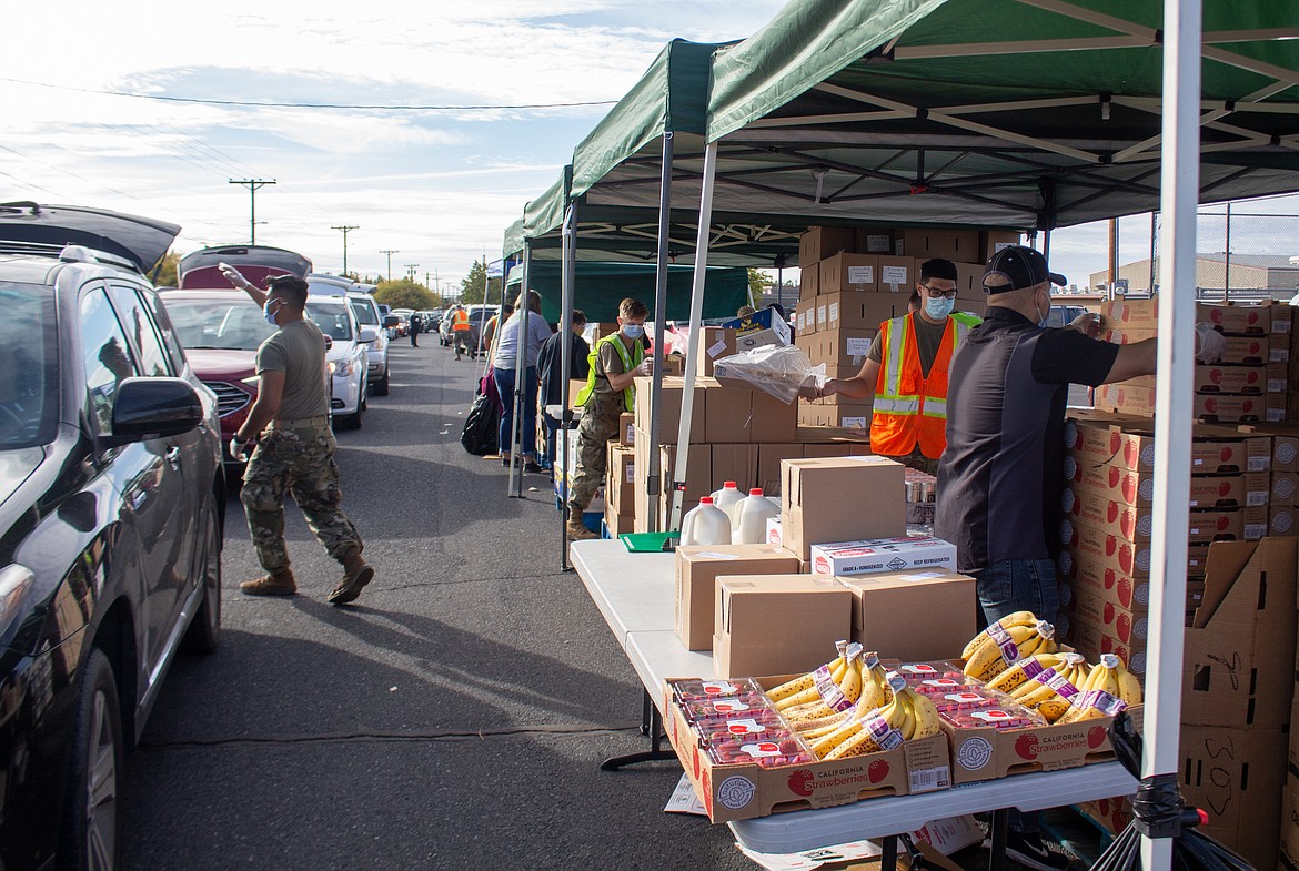 Cars lined up down and around the Othello High School parking lot on Tuesday afternoon as people came out for the Mobile Market food distribution offered by Second Harvest.