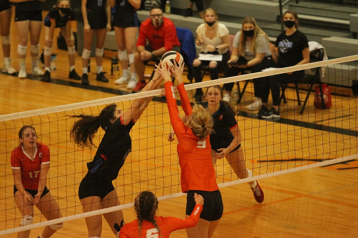 MARK NELKE/Press
Skylar Burke, left, of Coeur d'Alene and Rylee Hartwig of Post Falls joust at the net during Tuesday's 5A Region 1 volleyball championship match at The Arena at Post Falls. Covering for Coeur d'Alene are Maggie Bloom, left, and Madi Symons.