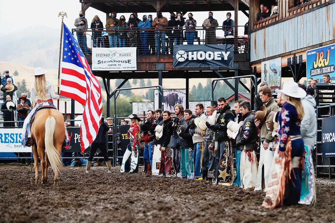 Rodeo cowboys and spectators salute the flag at the 2020 Darby, Montana, Riggin' Rally.