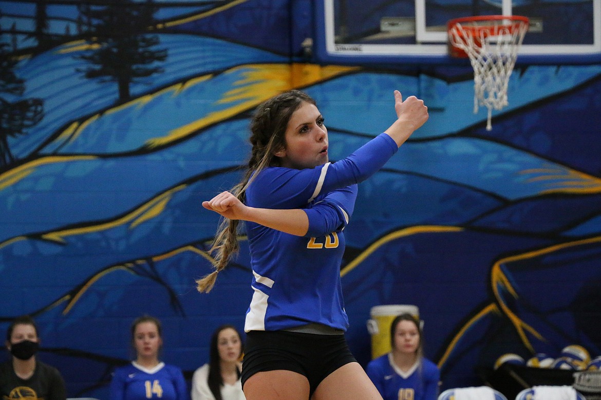 Sophomore Paige Valliere celebrates after the Lady Cats win a point during Tuesday's district match against Kootenai.