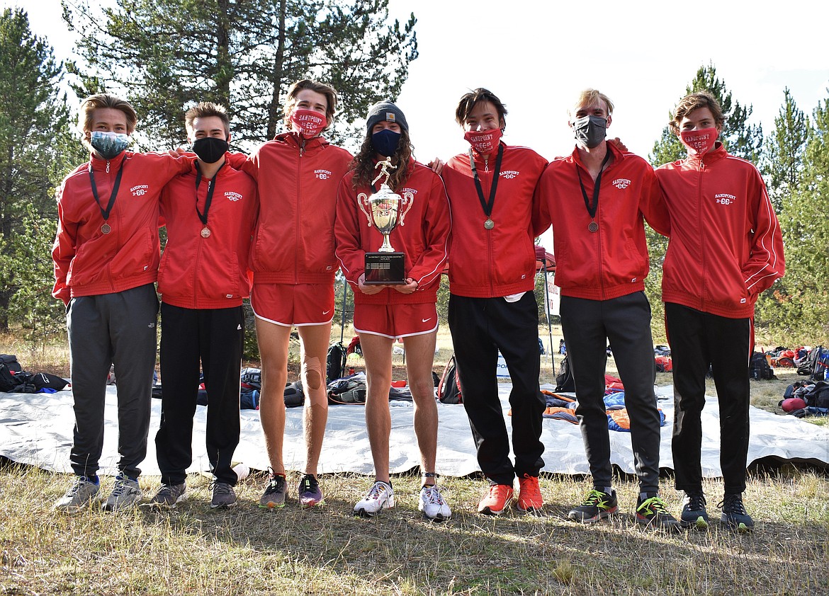 The varsity seven for the Sandpoint boys cross country team poses for a photo with the district trophy following Thursday's meet at Farragut State Park.
