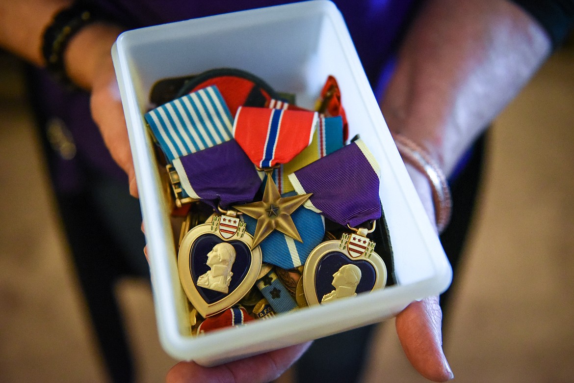 Sharon Peetz holds a collection of medals, including two Purple Hearts and a Bronze Star, her father Jack Pettitt earned during his time in the Army. (Casey Kreider/Daily Inter Lake)