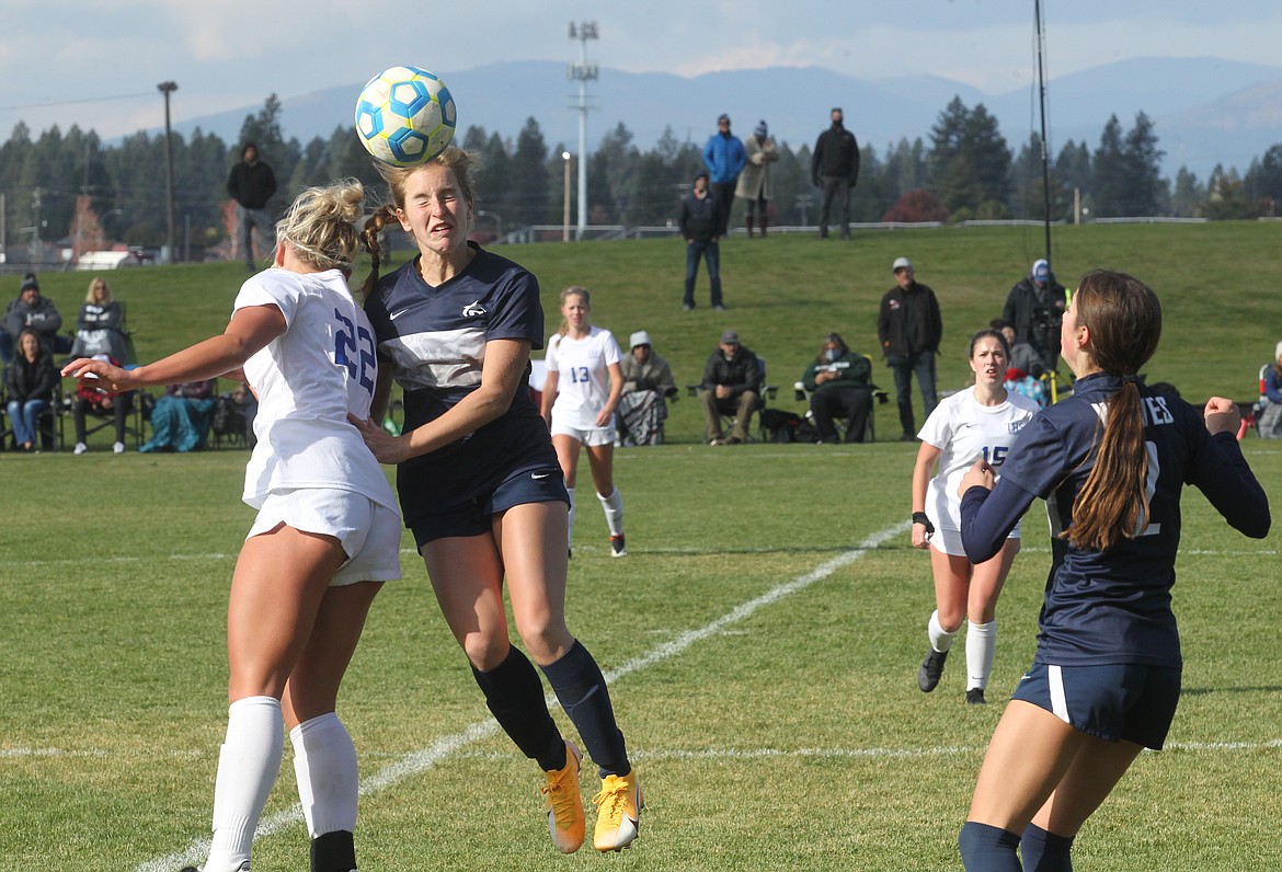 MARK NELKE/Press
Claire Romero, right, of Lake City heads the ball as Lily Anson (22) of Timberline challenges on Thursday.