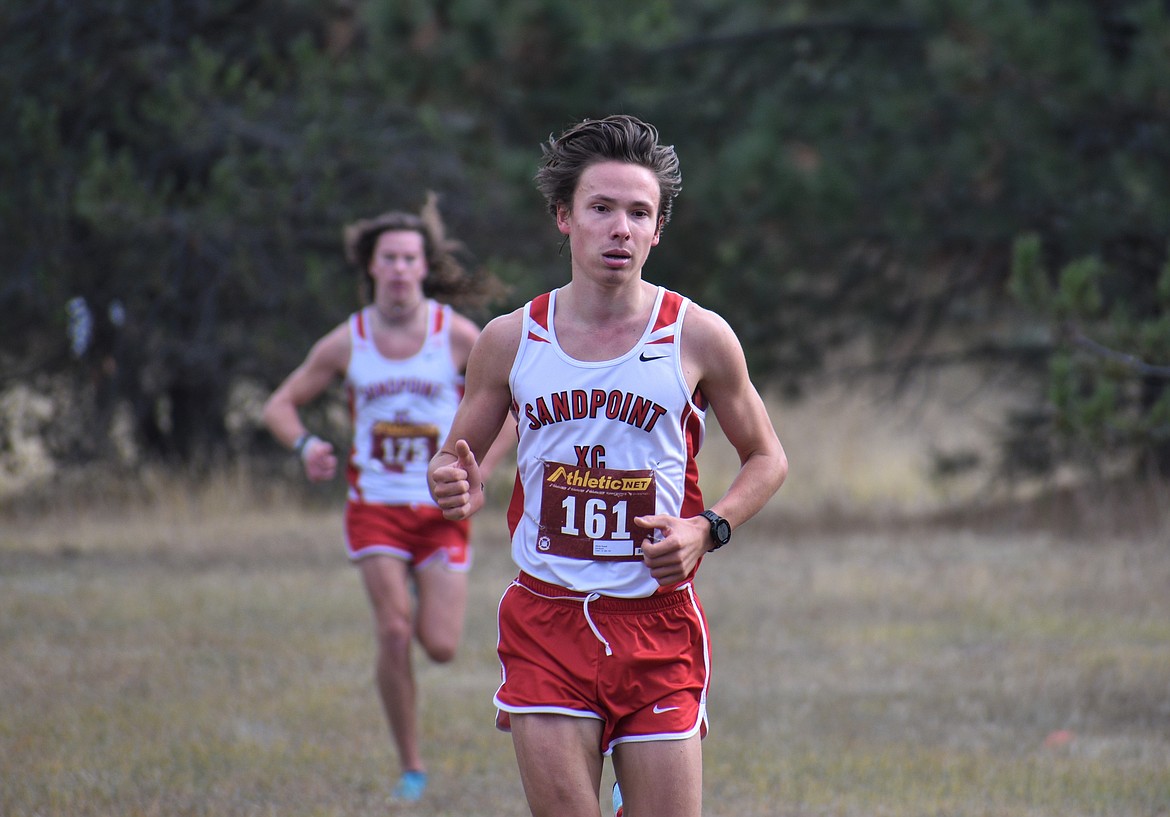 Nikolai Braedt leads the way as his teammate, Jett Lucas, trails closely behind during the 4A Region 1 cross country championship on Oct. 22 at Farragut State Park. Braedt won his third straight district title.