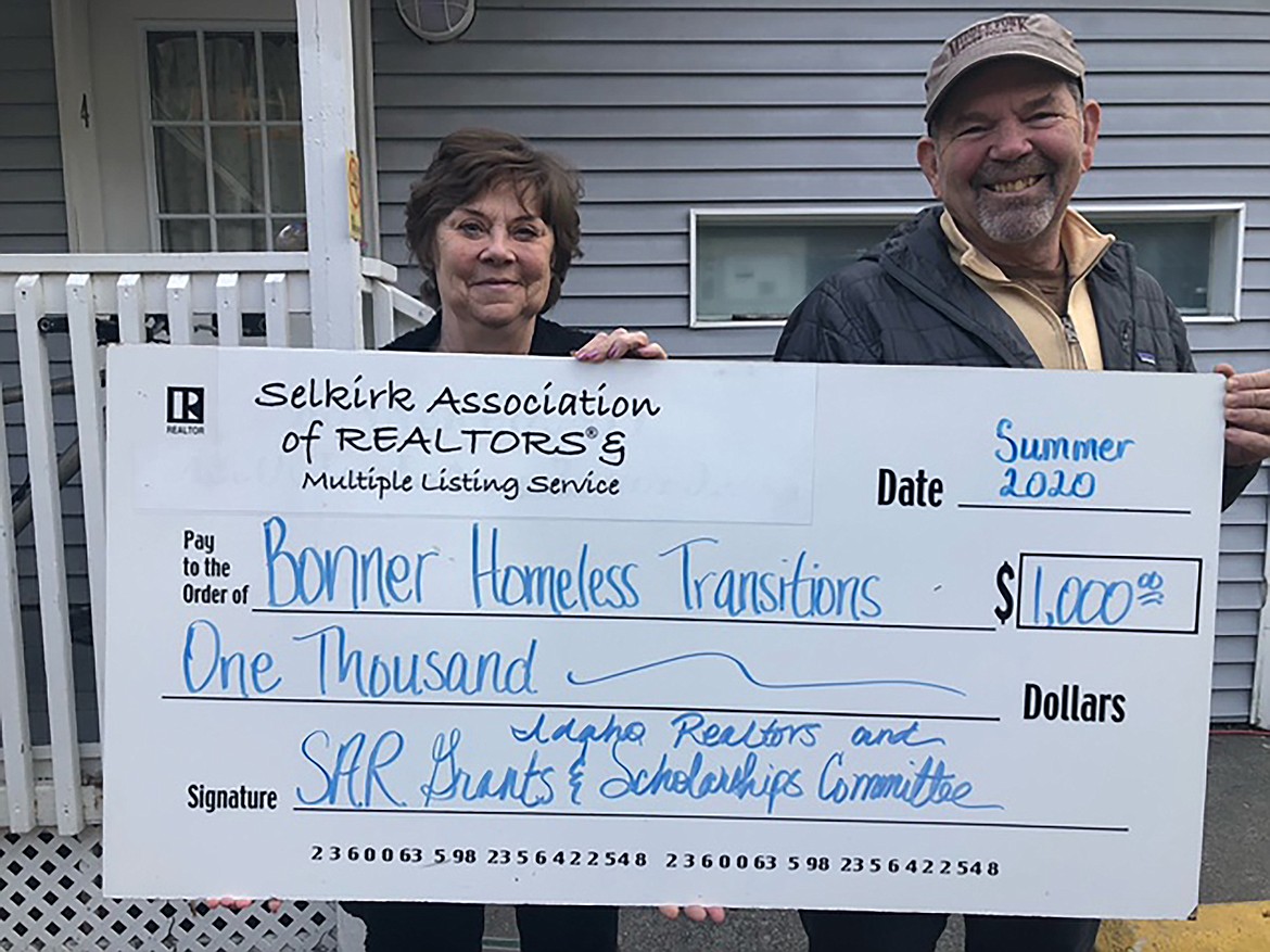 Joanne Barlow, director of Bonner Homeless Transitions, is presented a donation from Forrest Schuck, Selkirk Association of Realtors state director. The association, in conjunction with Idaho Realtors, recently presented Bonner Homeless Transitions with a $1,000 grant to purchase a wooden playground set for the children who stay at the home located off Michigan Street in Sandpoint.