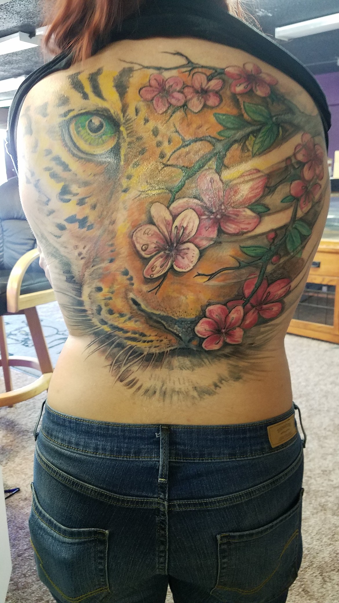 Courtesy photo
Jamie Galabasni displays an award-winning tattoo on her back which was created by Daemon Cusco, who will open 2 Ravens Studio Tattoo by Nov. 1 at 1119 E. Sherman Ave.