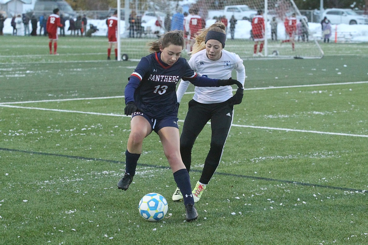 JASON ELLIOTT/Press
Coeur d'Alene Charter Academy senior defender Kiley Cutler attempts to dribble away from the Sugar-Salem defense during the first half of Saturday's state 3A girls soccer championship at The Fields in Post Falls.