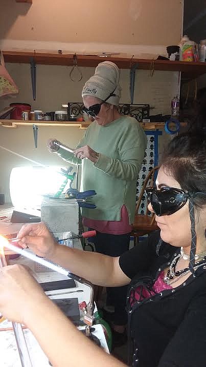 Ramah Vulles (front) and Tif Chrysler making Hearts of Hope in Chrysler's studio in Superior. (Monte Turner/Mineral Independent)