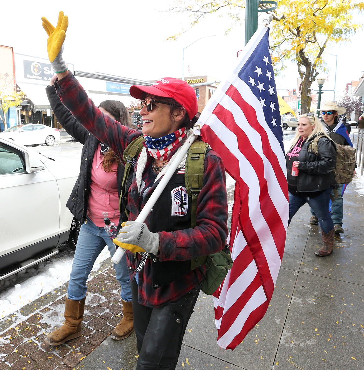 A woman who said she lives in Spokane and goes by "Butterfly" holds a flag on Sherman Avenue Saturday during the rally for President Donald Trump.