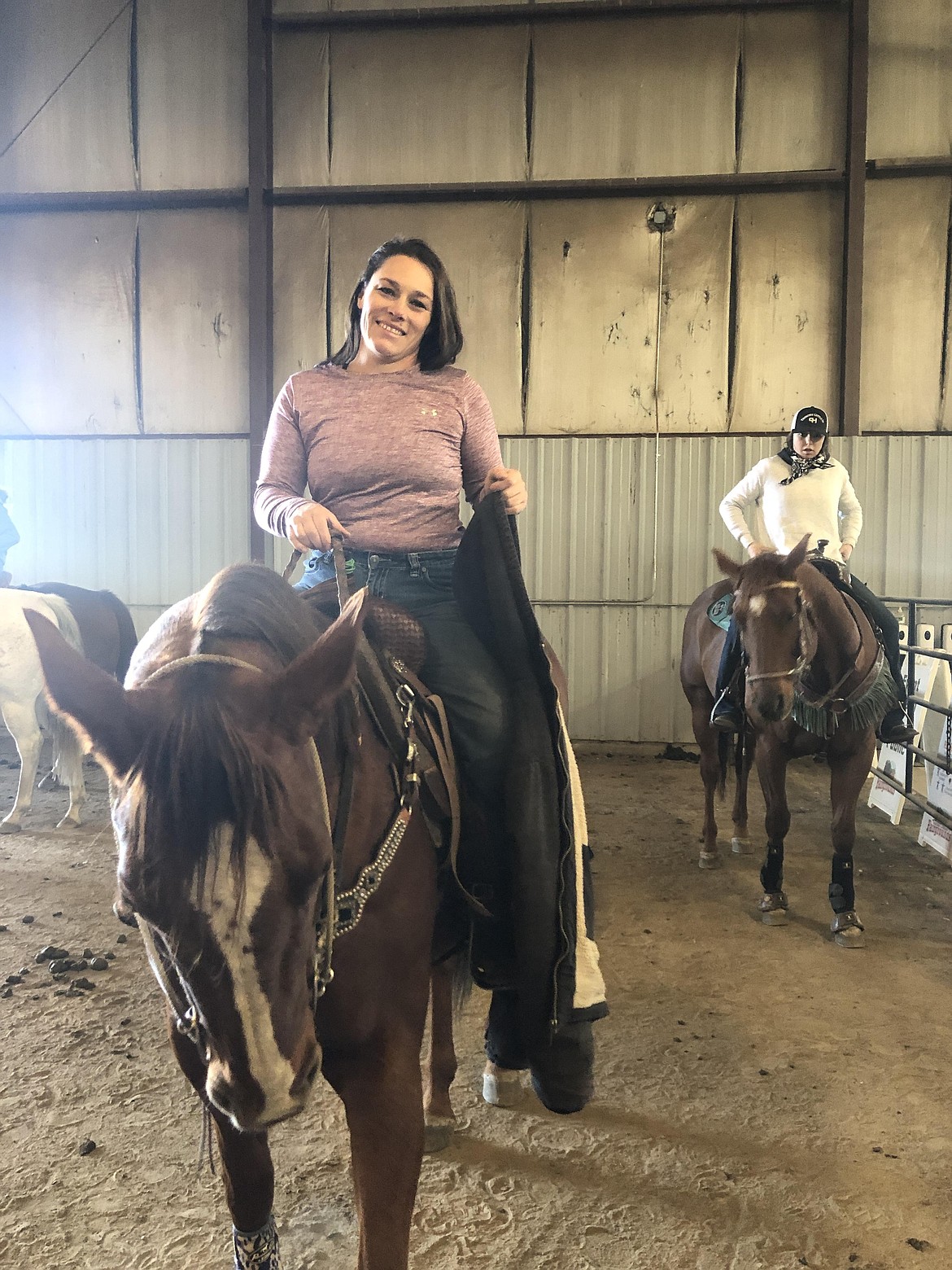 April Hollander, 36 (front), and Lexi Thompson, 15 (back), wait to race at the Columbia Basin Barrel Racing Club's winter finals at the Gran County Fairgrounds on Saturday.