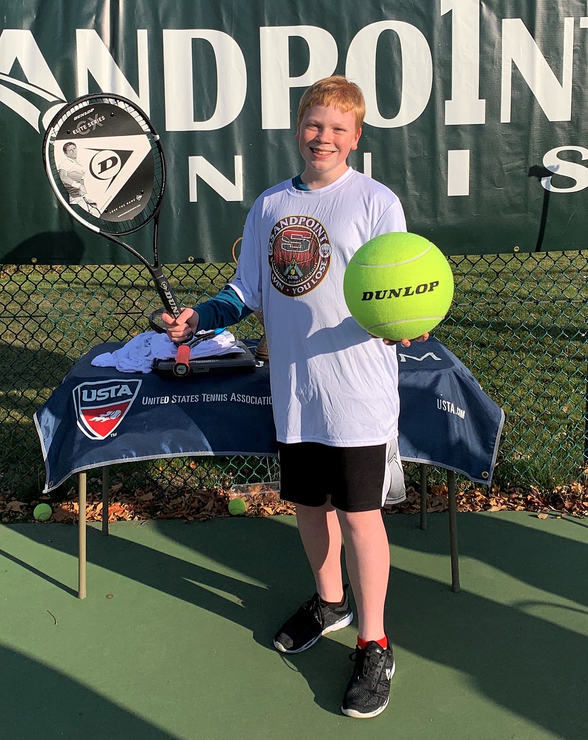 Brennan Johnson smiles after claiming the Bombers vs. Rollers tournament title on Thursday, Oct. 22. The event put a cap on the Sandpoint Middle School tennis season. Johnson was awarded a new Dunlop Elite tennis racquet for winning.