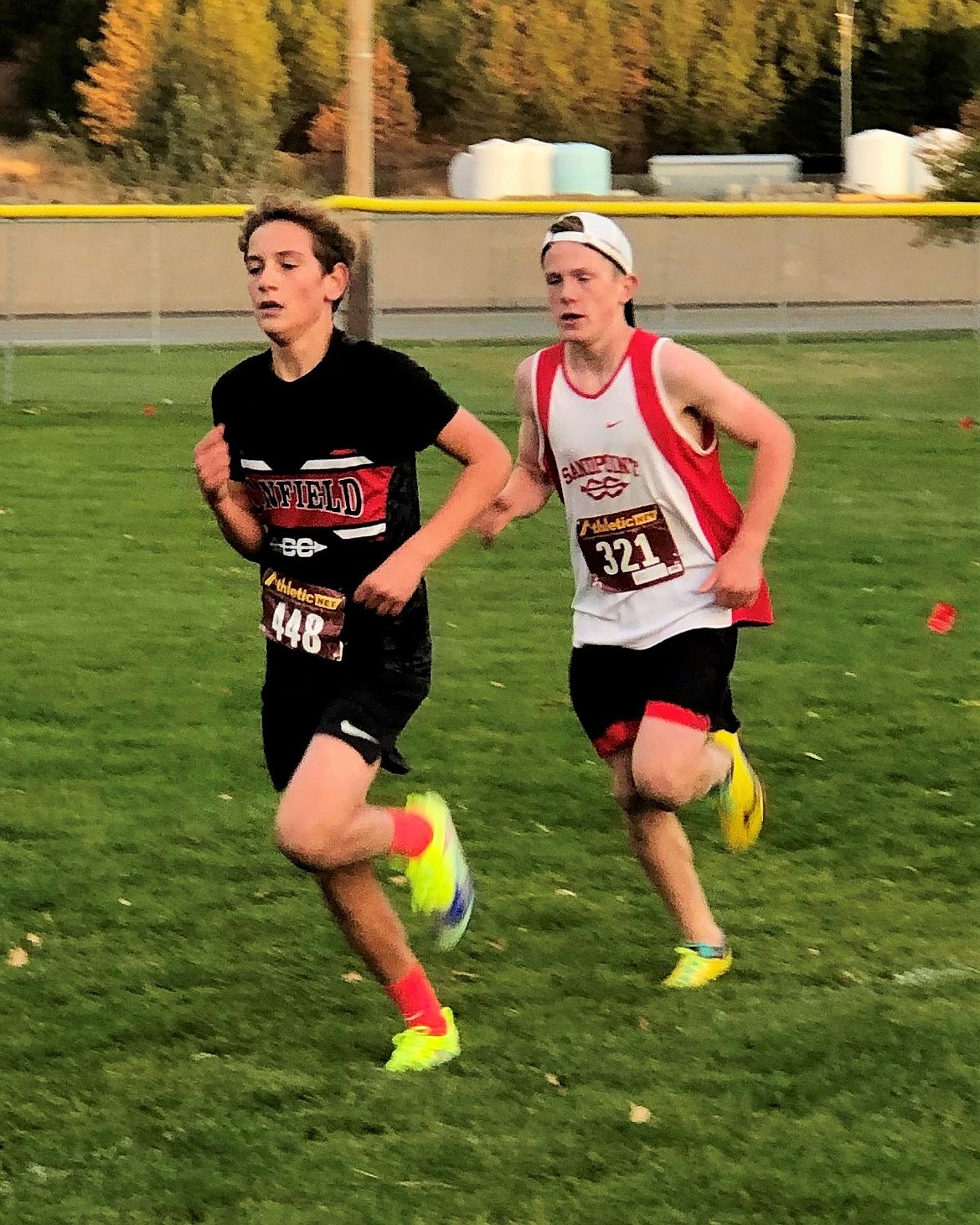 Callahan Waters, (right), keeps pace with a Canfield runner during the district championships on Tuesday, Oct. 20 at Ramsey Park.