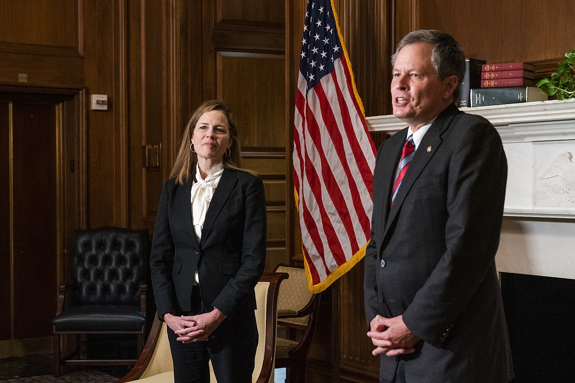 Supreme Court nominee Judge Amy Coney Barrett, meets Sen. Steve Daines, R-Mt. on Capitol Hill, Thursday, Oct. 1, 2020, in Washington. (AP Photo/Manuel Balce Ceneta, POOL)