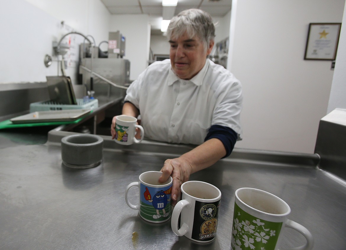 Linda Barnhart, kitchen assistant at Lake City Center, clears coffee mugs from a dish table in Lake City Center on Oct. 21. Barnhart celebrated 30 years of working at the center on Oct. 12.