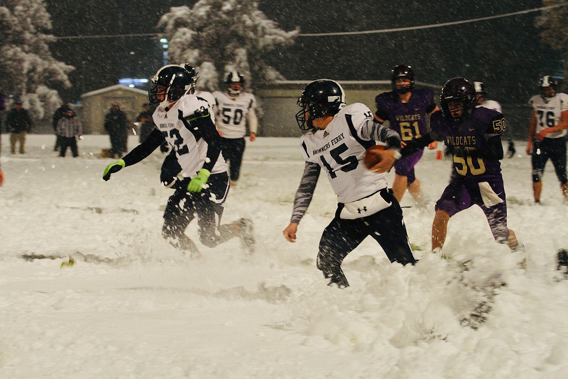 Kellogg's Roman Bisaro chases down Bonners Ferry's Tiegan Banning during the first half of the Snow Bowl in Kellogg.