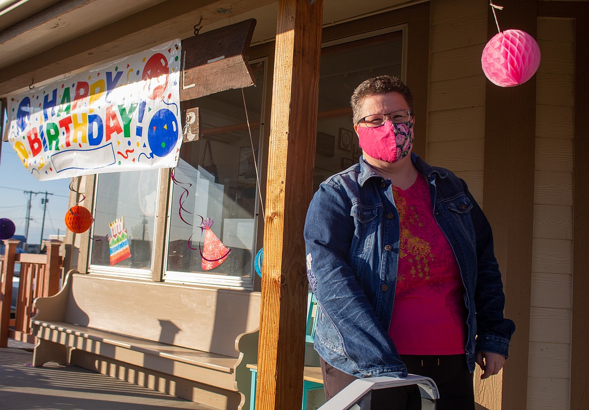 Jenn Stevenson, Director at the Old Hotel Art Gallery in Othello, stands on the front porch of the gallery on Saturday as meals are handed out for the Birthday Benefit.