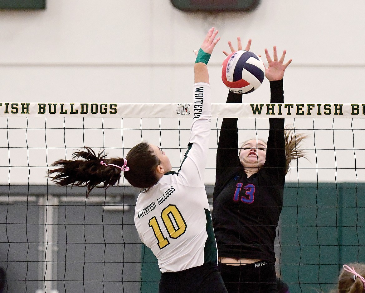Grace Gedlaman reaches for a block against Whitefish last week. (Teresa Byrd/Hungry Horse News)