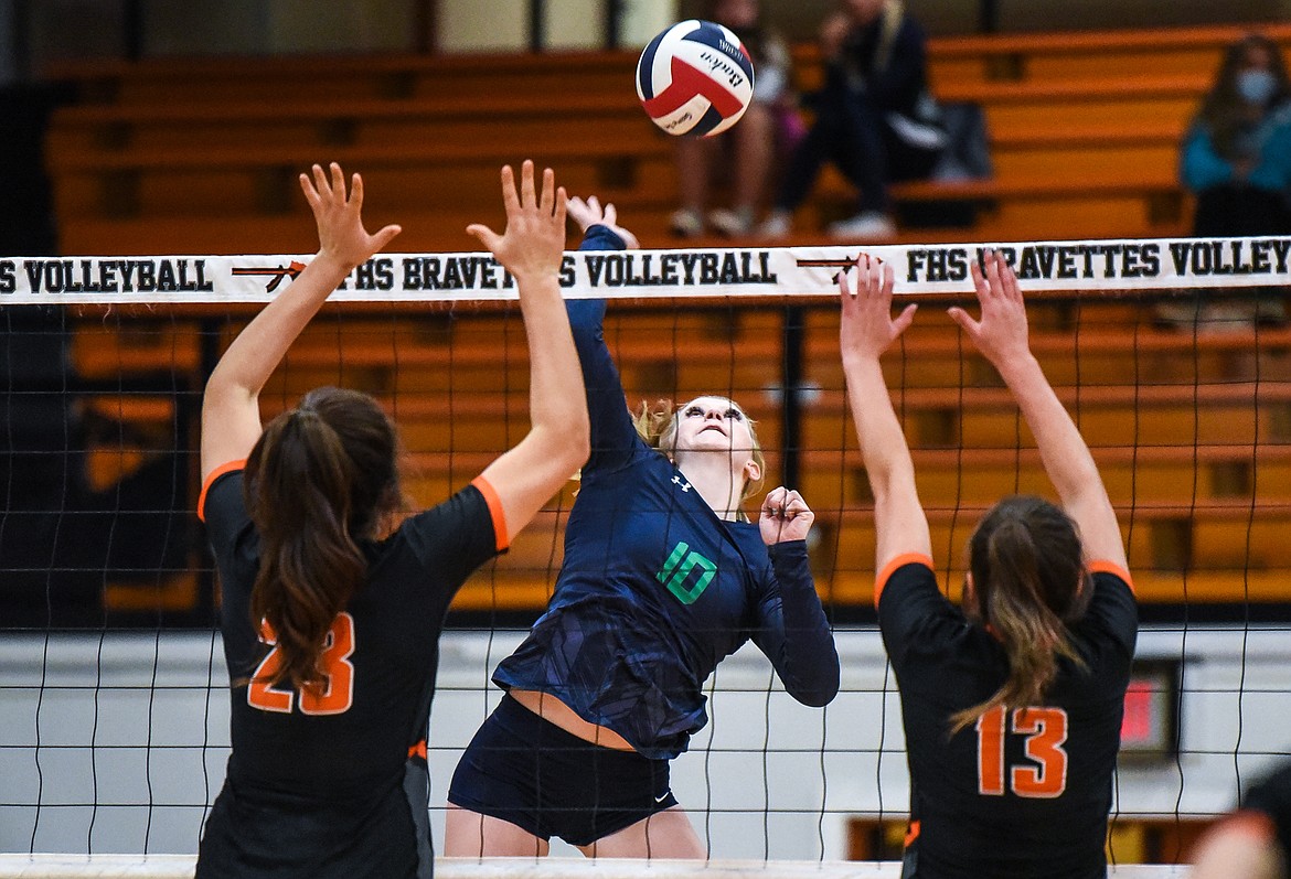 Glacier's Kynzie Mohl (10) goes up for a kill against Flathead's Savanna Sterck (23) and Maddi Chavez (13) during crosstown volleyball at Flathead High School on Tuesday. (Casey Kreider/Daily Inter Lake)