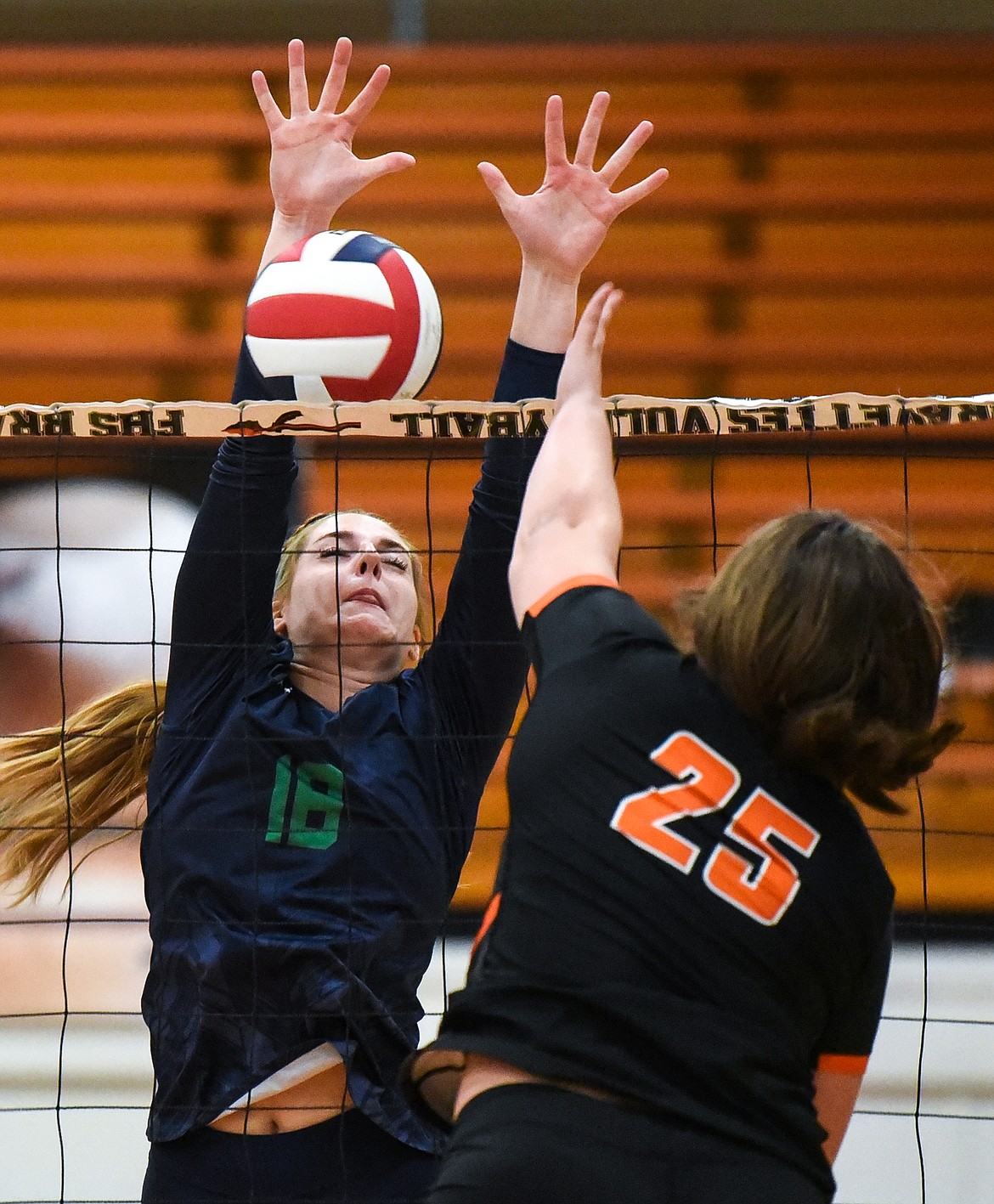 Glacier's Mady Toren (18) blocks a spike from Flathead's Alliyah Stevens (25) during crosstown volleyball at Flathead High School on Tuesday. (Casey Kreider/Daily Inter Lake)