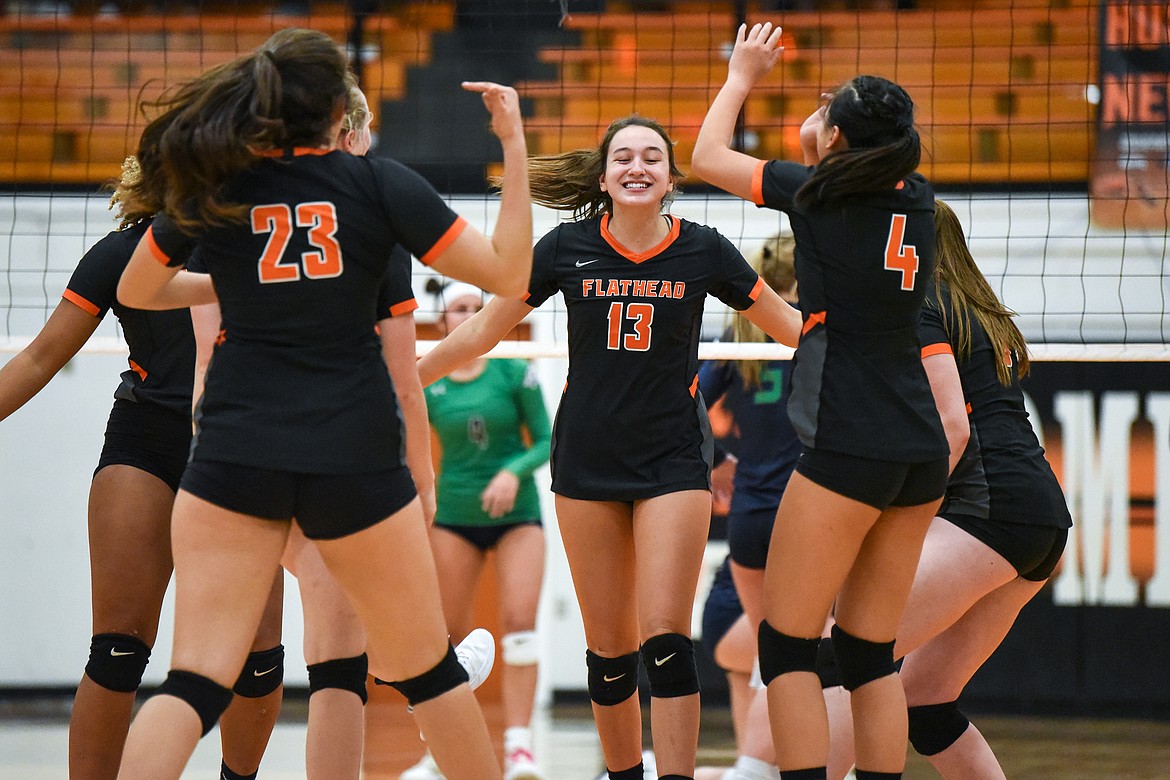 Flathead's Maddi Chavez (13) celebrates with fellow Bravettes after a point against Glacier during crosstown volleyball at Flathead High School on Tuesday. (Casey Kreider/Daily Inter Lake)