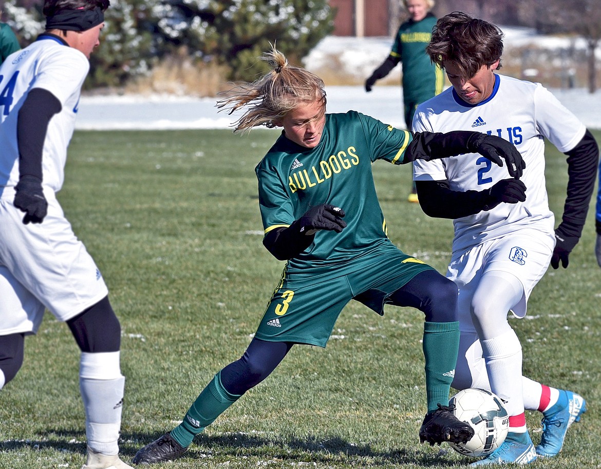 Whitefish's Chase Sabin tries to dribble around a Corvallis defender during a Class A semifinal game at Smith Fields on Saturday. (Whitney England/Whitefish Pilot)