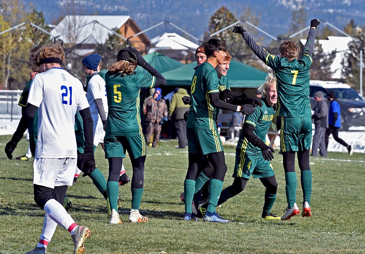 Whitefish's Aaron Dicks (7) celebrates his first-half goal with his teammates as the Bulldogs defeat Corvallis 6-0 in a Class A semifinal match Saturday. (Whitney England/Whitefish Pilot)