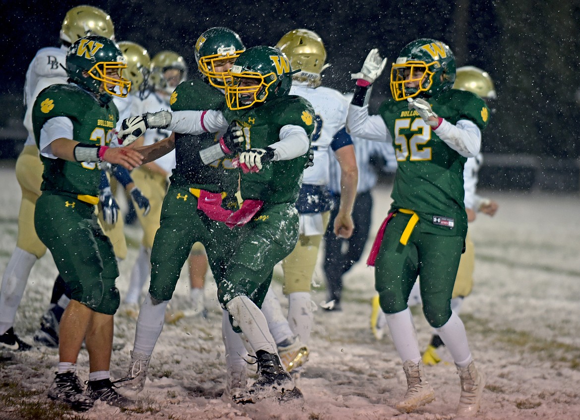 Whitefish lineman Camren Ross celebrates an unassisted sack with his teammates in a game against Dillon Friday night at the Dog Pound. (Whitney England/Whitefish Pilot)