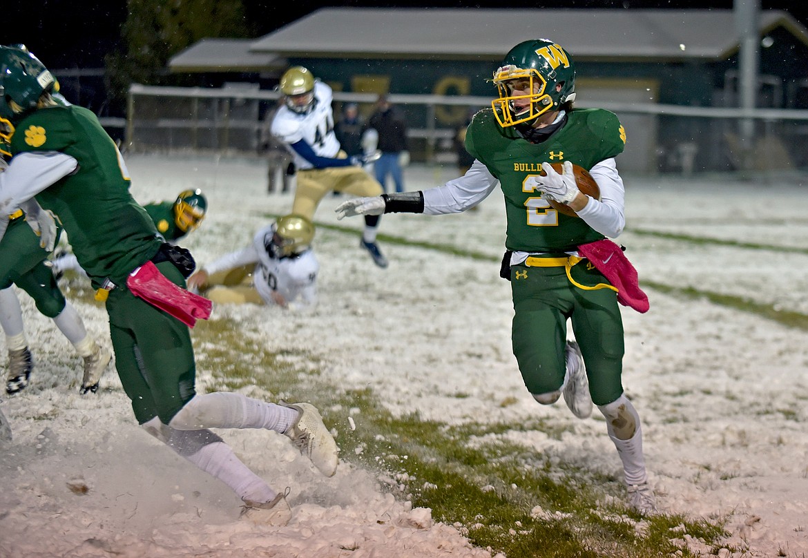 Bulldog Bodie Smith looks for room to run in a game against Dillon Friday night at the Dog Pound. Smith had 138 receiving yards in the game. (Whitney England/Whitefish Pilot)