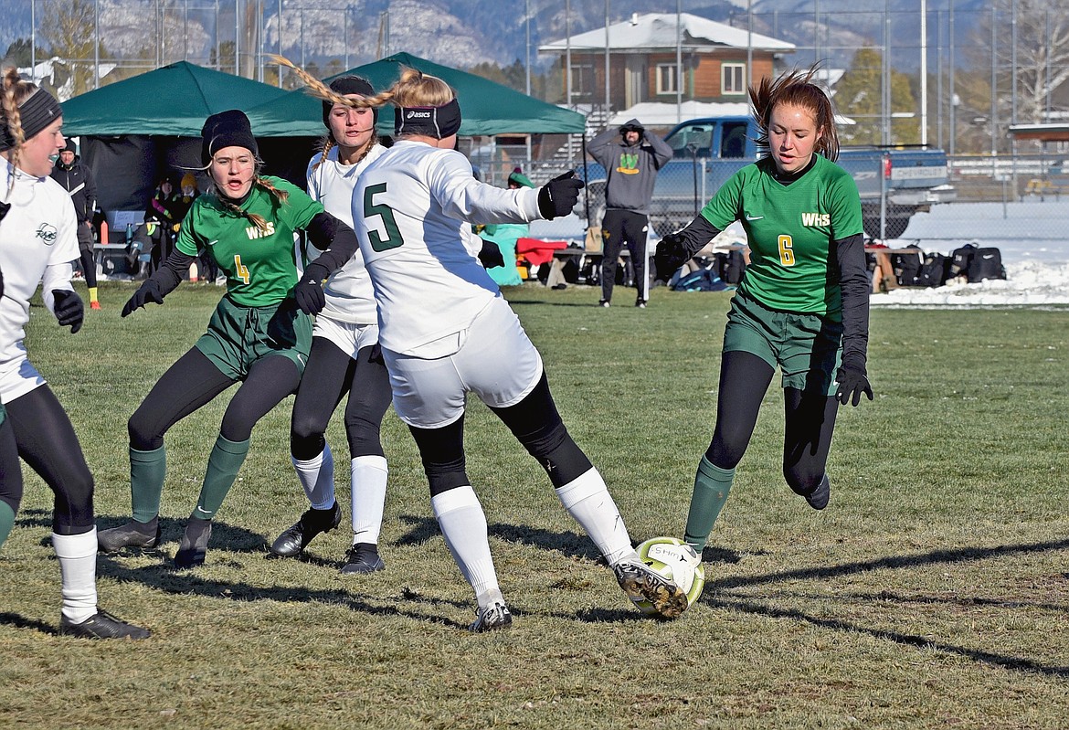 Lady Bulldogs Adrienne Healy (6) and Sophie Olson (4) crash towards Billings Central's goal in an attempt to score in a Class A semifinal game against the Rams Saturday at Smith Fields. (Whitney England/Whitefish Pilot)