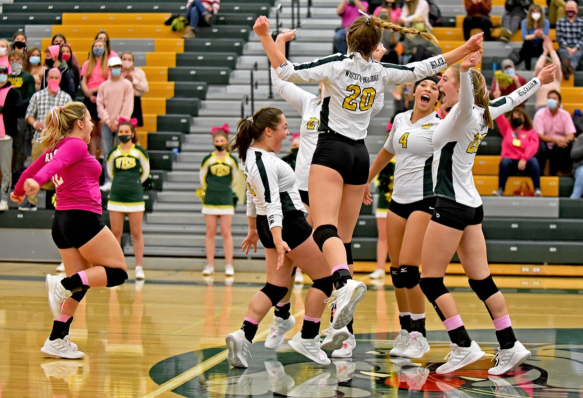 Whitefish volleyball players celebrate winning a point in a game against Columbia Falls Thursday in Whitefish. (Whitney England/Whitefish Pilot)