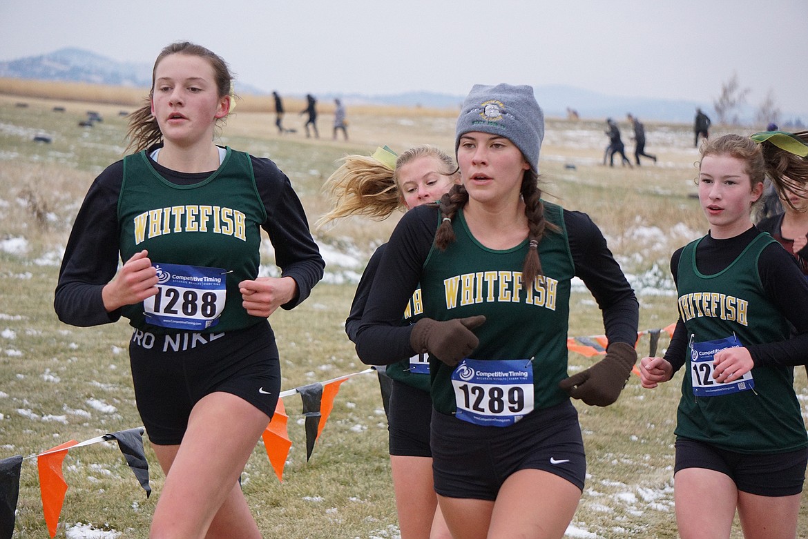 A pack of Bulldogs Maggie Pulsifer, Morgan Grube, Alie Simpson and Hazel Gawe run together at the state Class A championship meet on Friday at Rebecca Farm. (Matt Weller photo)