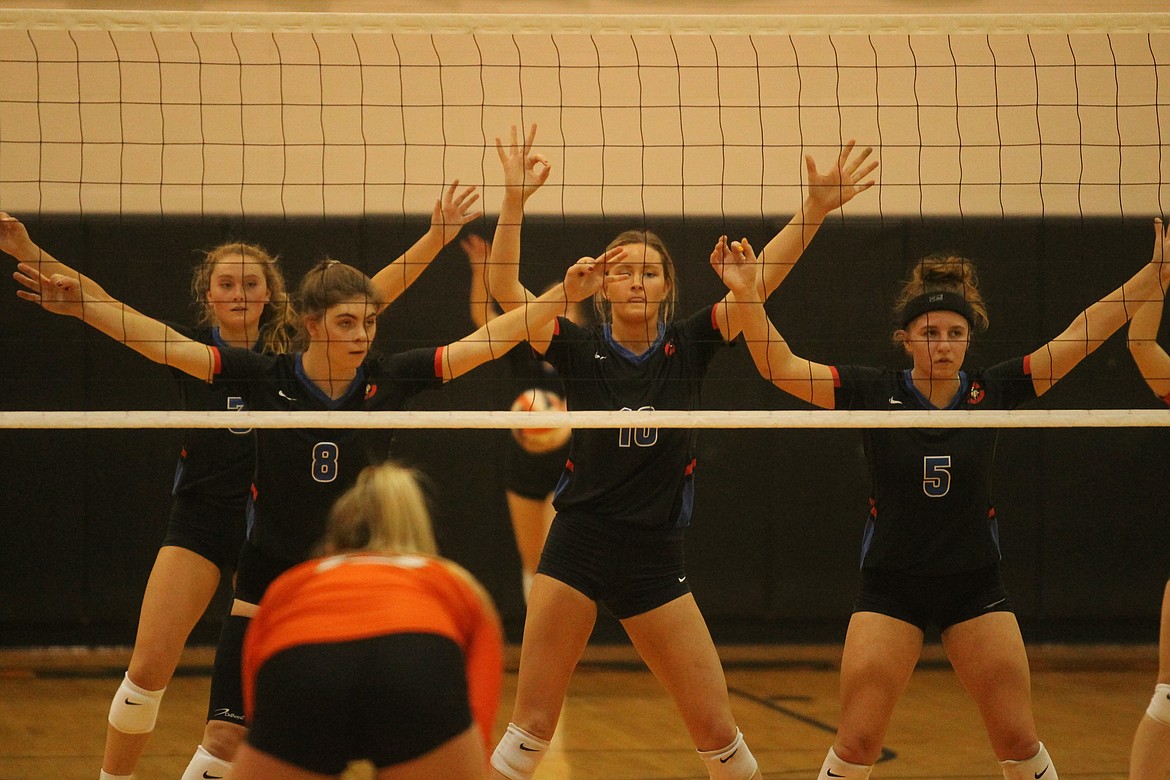 MARK NELKE/Press
With Kate Phillips (8), Angela Goggin (10) and Sarah Wilkey (5) in front, and Lauren Phillips (3) behind them, the Coeur d'Alene Vikings form a wall as a teammate prepares to serve. "It’s a legal setup, so you can make kinda like a wall, so they have to see around it," Coeur d'Alene coach Carly Curtis said. "You’ll see that a lot if you watch the college level, or the men’s game. The men do it a ton. We’ve worked on toughening up our serves, and it’s paid off."