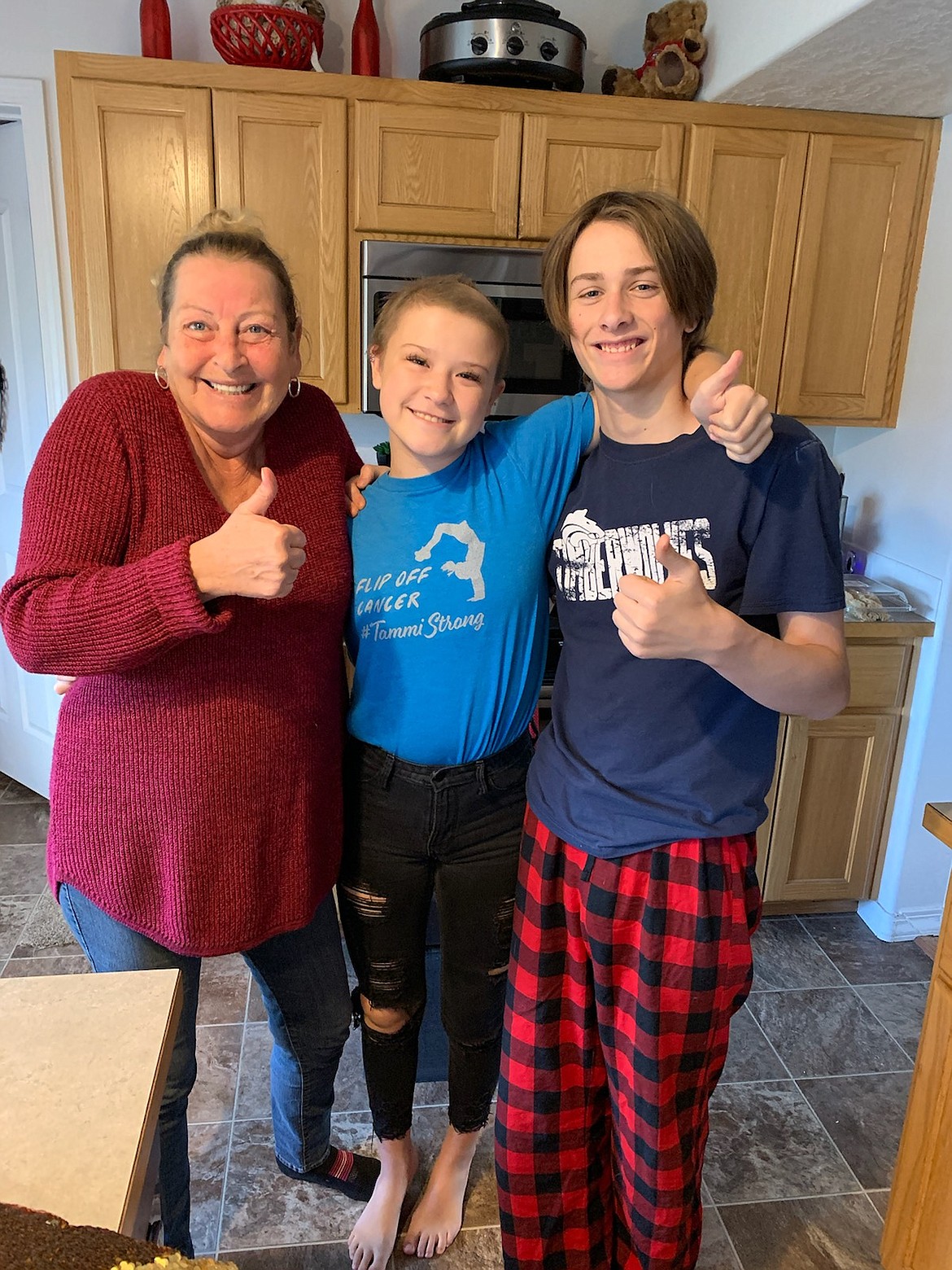 Tammi Hite, center, and grandma Ladonna Umland and big brother Tanner Hite are all smiles last Wednesday as they get the news that Tammi's brain cancer is disappearing.