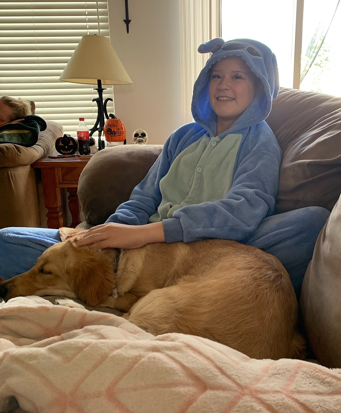 Tammi Hite, 12, of Coeur d'Alene, is seen here at home with her dog, Scout, after she underwent an MRI that revealed her brain cancer is shrinking and disappearing. "I was excited," Tammi said. "I had happy tears flowing."