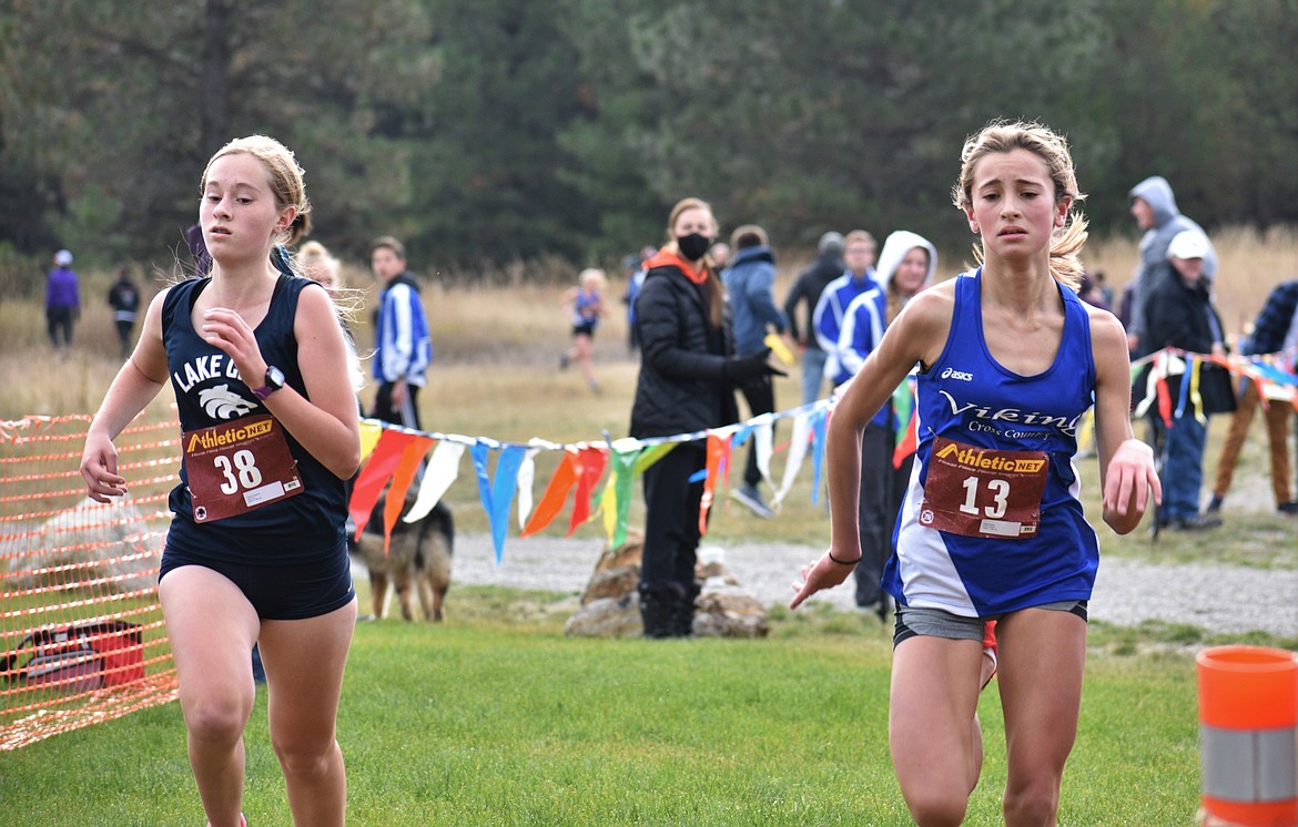 DYLAN GREENE/Bonner County Daily Bee
Lake City's Taylah Chapman (left) and Coeur d'Alene's Elliana Rietze cross the finish line of the 5A Region 1 girls race on Oct. 22 at Farragut State Park.