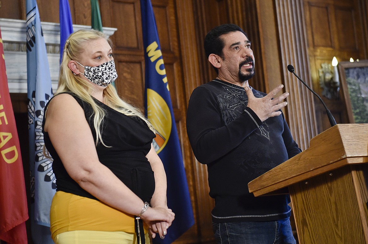 Butte resident Gilbert Herrera, right, tells the story of his battle with COVID-19 on Thursday, Oct. 29, 2020, during a press call hosted by Gov. Steve Bullock at the state Capitol in Helena, Mont.. Also pictured is Herrera's wife, Gina Sandon, who was also hospitalized for Covid-19.(Thom Bridge/Independent Record via AP)