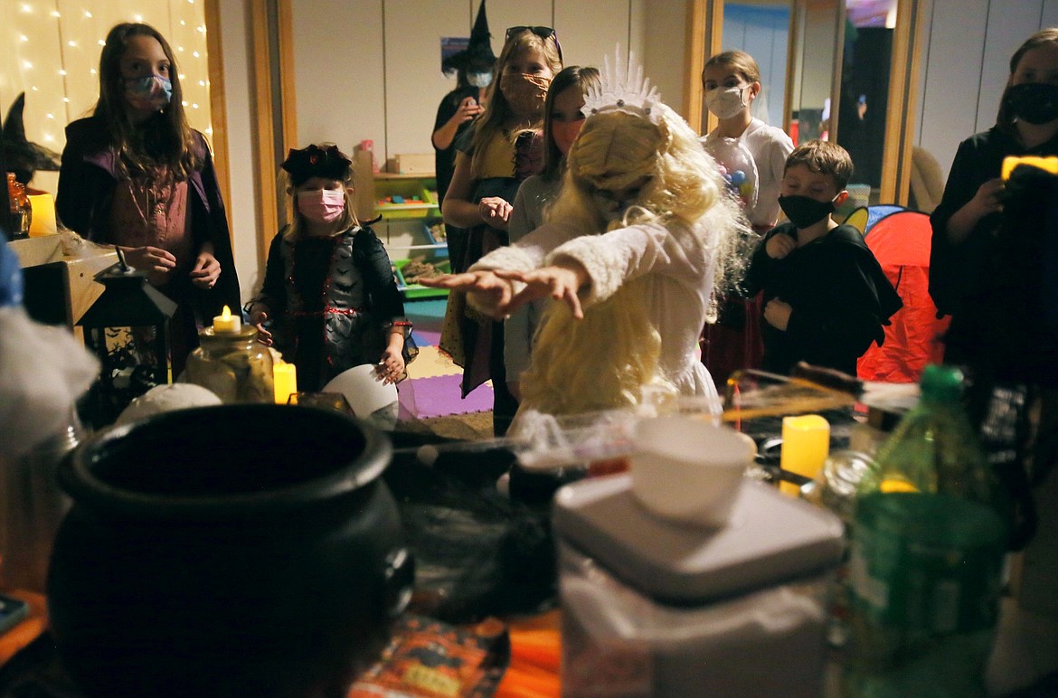 Sage Moyer, 8, of Hayden, uses her ice princess powers to help a cauldron bubble during a STEM-themed Halloween party in the Silver Lake Mall on Wednesday.