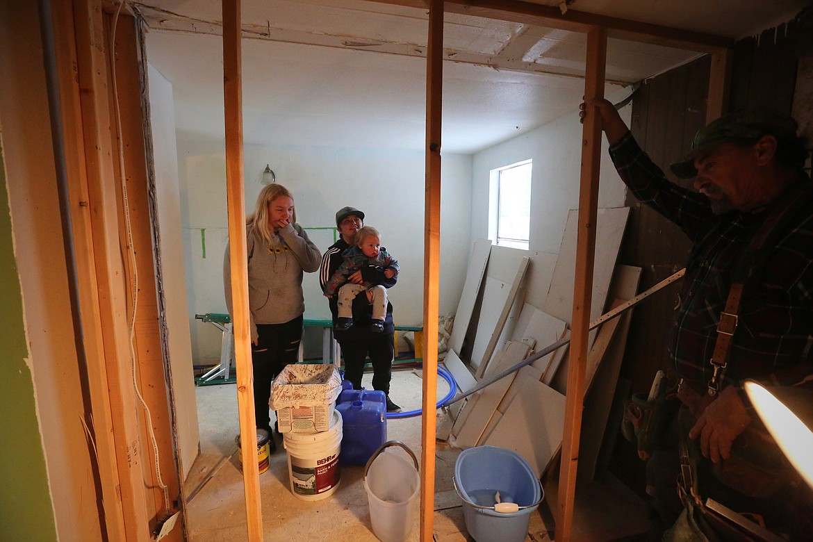 Makynzie Kurns, 19, her son Graycen, 1, and her partner Gracelynn Romaine, 19, take a first look at the rehabilitation of their trailer in Evergreen.
Mackenzie Reiss/Daily Inter Lake
