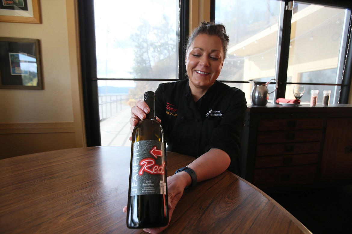 Cheyenne D'Alessandro, who has co-owned Tony's on the Lake for 16 years, shows off a bottle of Jeanette's red wine on Oct. 22. The wine was named for Jeanette Winters, who built Jeanette's Club, a bordello, on the site in 1939.