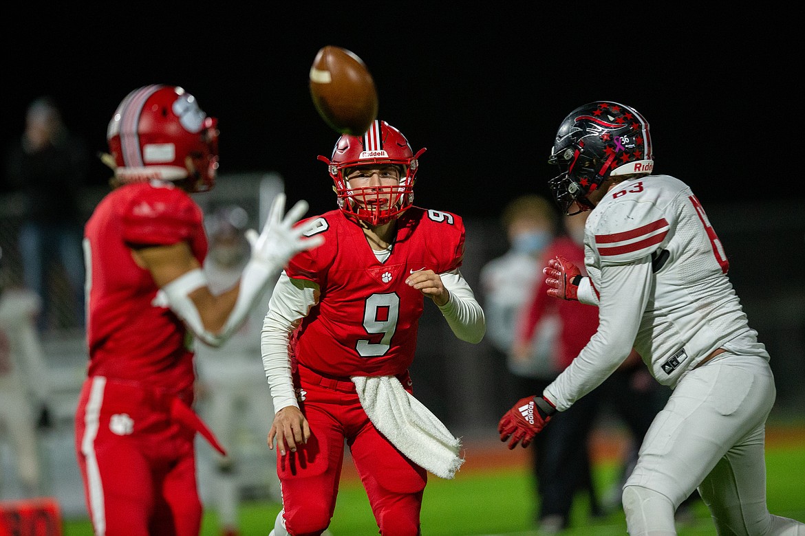 Quarterback Parker Pettit (right) throws a screen pass to Braden Kappen on Friday night at War Memorial Field.